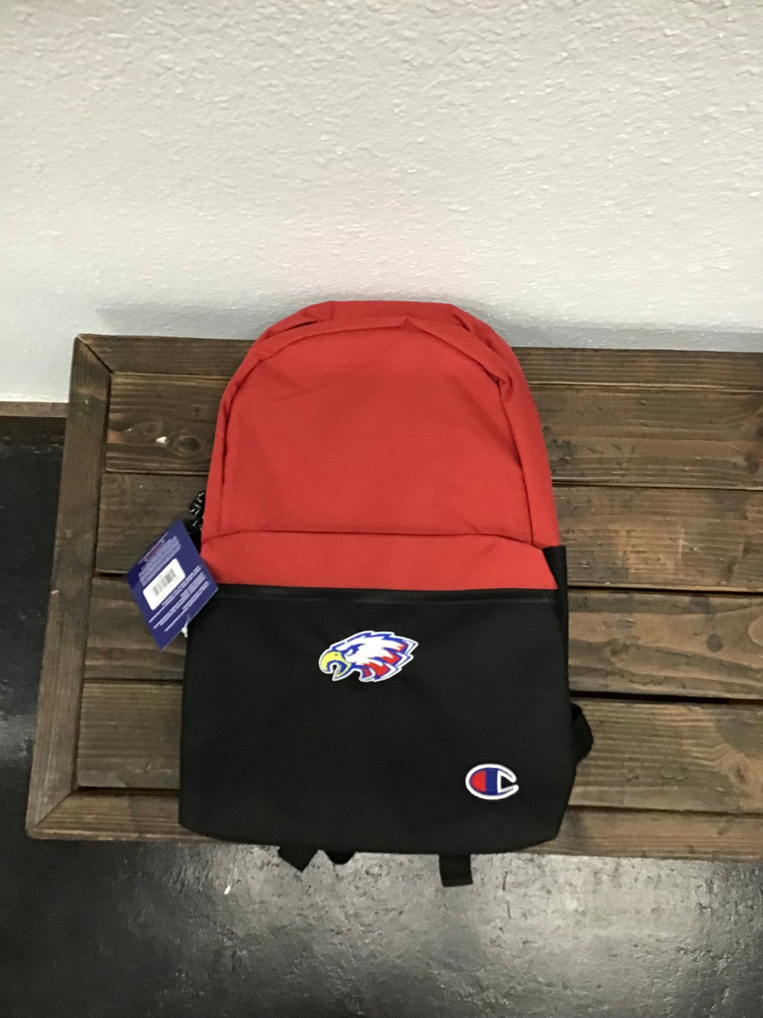 Champion back pack with antique red on top and black on bottom. Front zipper pocket and slit pockets on each side.