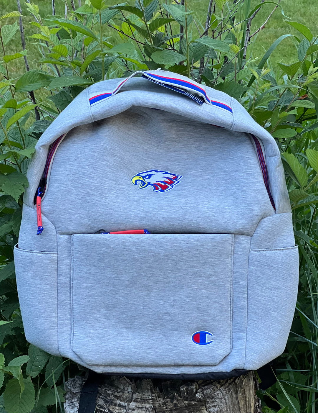 Heather Light Gray cloth Champion back pack. Eagle is embroidered onto the front. Laptop pouch on the inside, also has a front zipper pocket and pockets on either side.